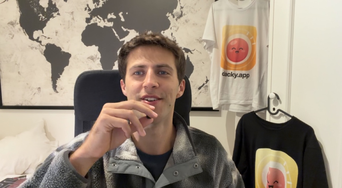 Justinas in his room with Clacky t-shirts on the wall